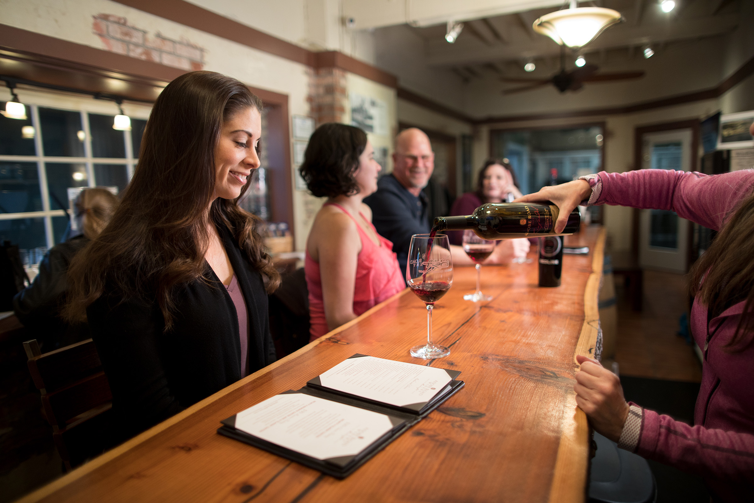 People tasting at the wine bar.